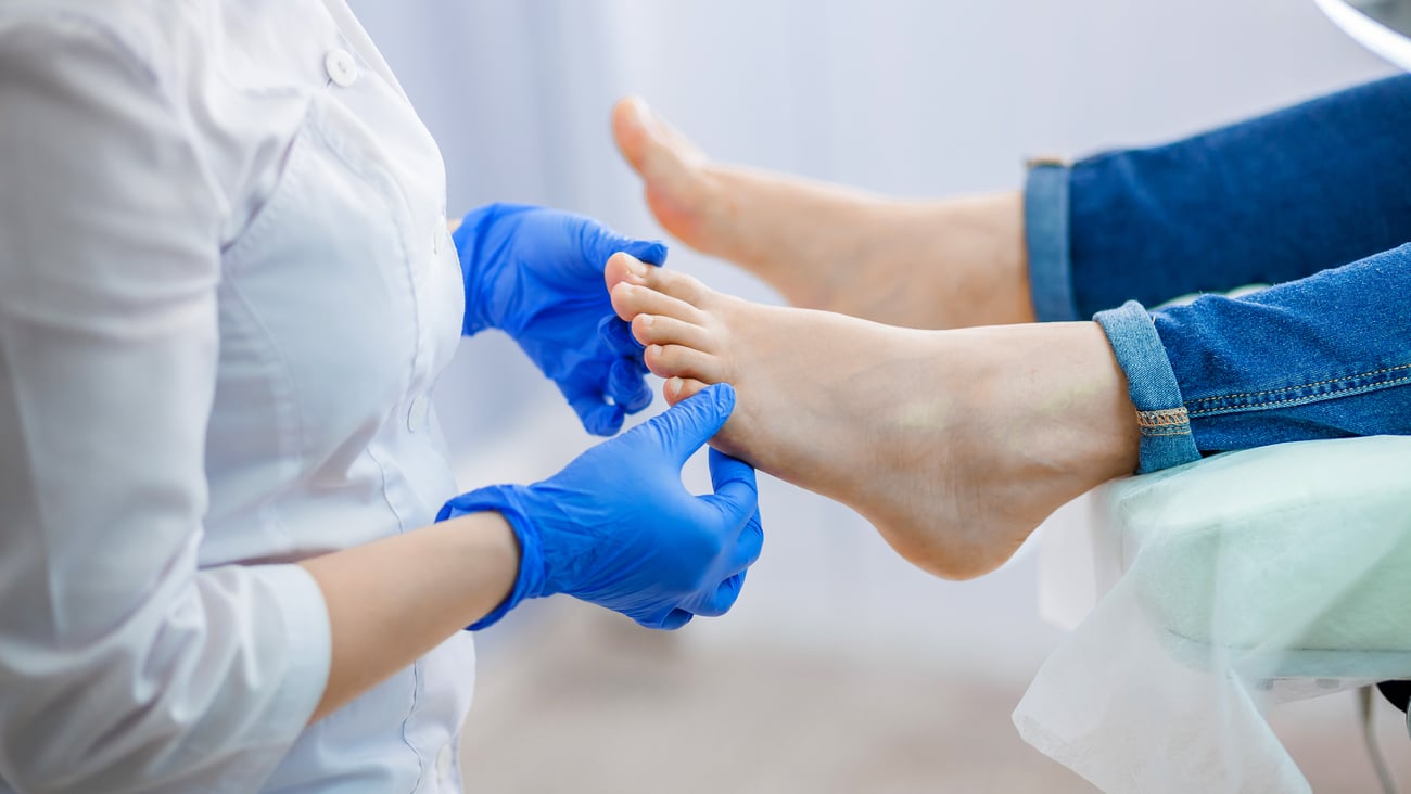 a hand holding a blue object