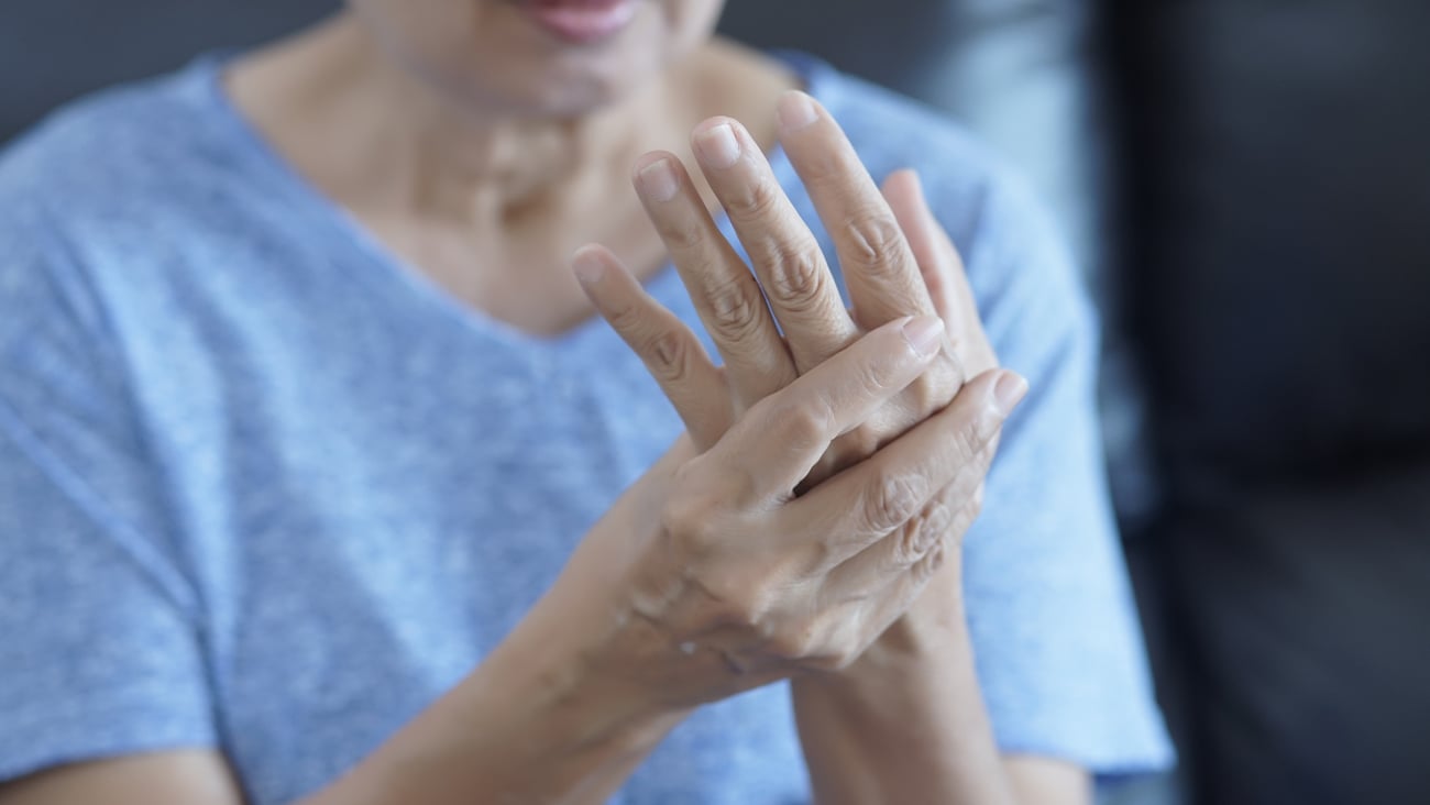 a woman holding her hand to her face