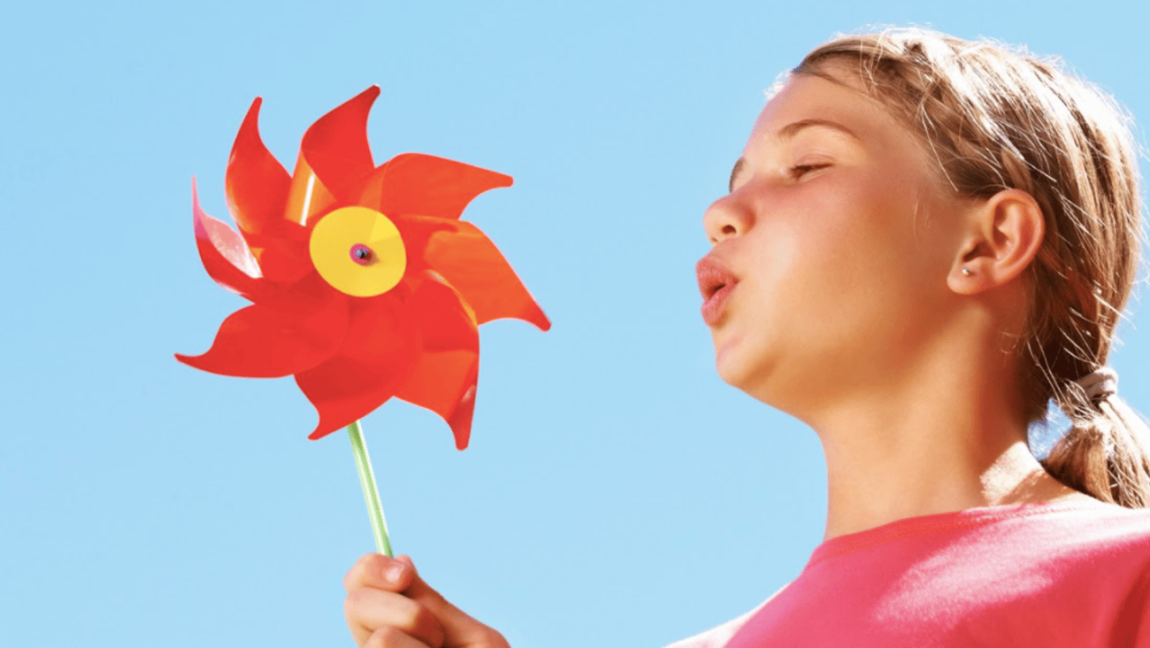 person,pinwheel,outdoor,holding,woman,wearing,kite,blue,shirt,head,man,young,water,player,standing,air,swinging,flying,umbrella