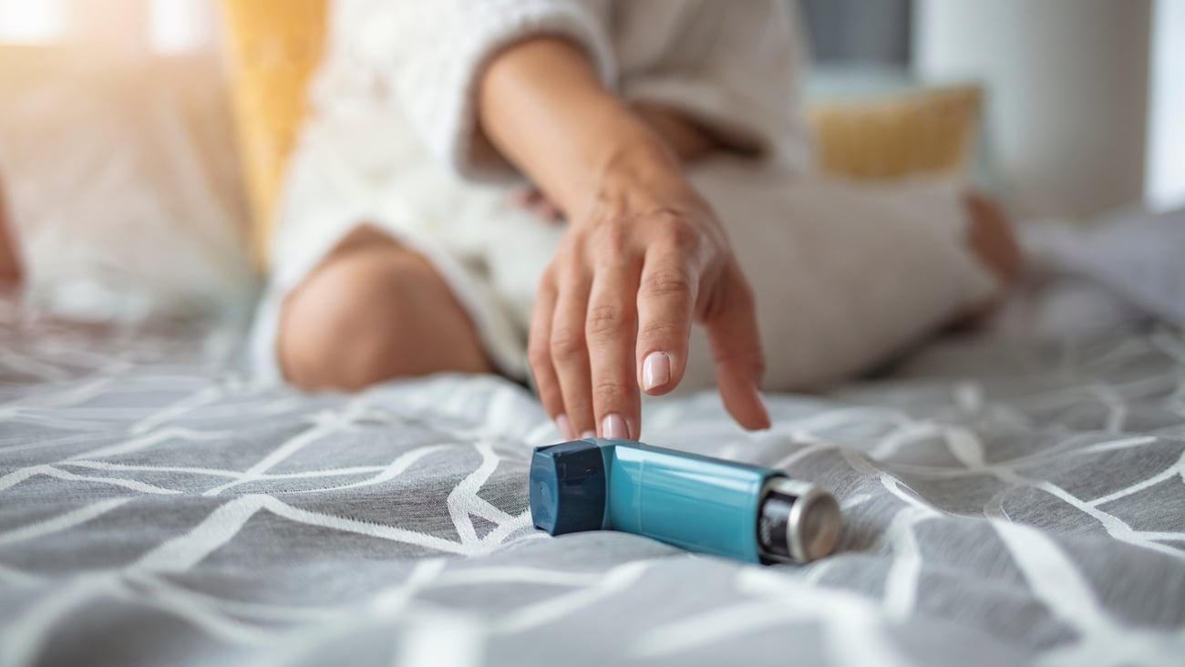 a close up of a person sitting on a bed