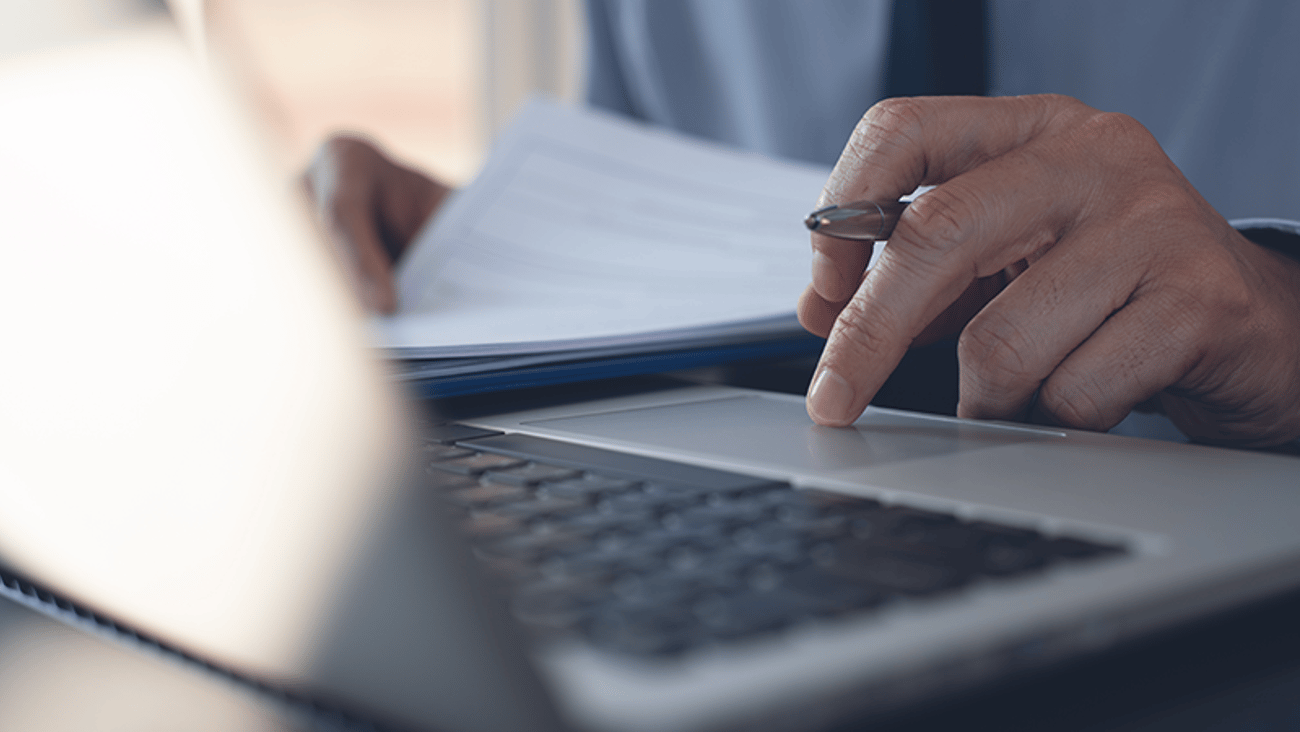 Man entering info into a laptop computer