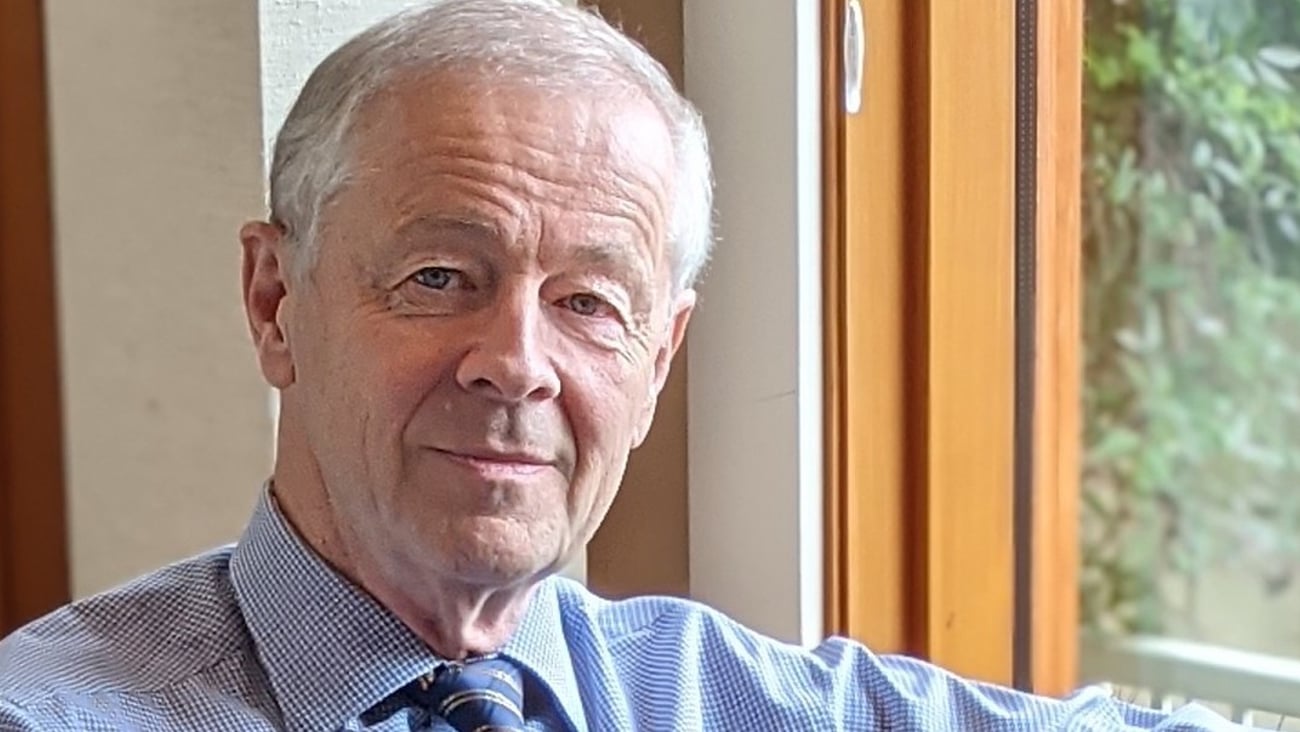 a man wearing a suit and tie looking at the camera