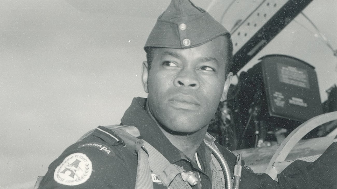 A photo from the 1960s shows Dr. Blizzard, a pilot standing beside a plane.