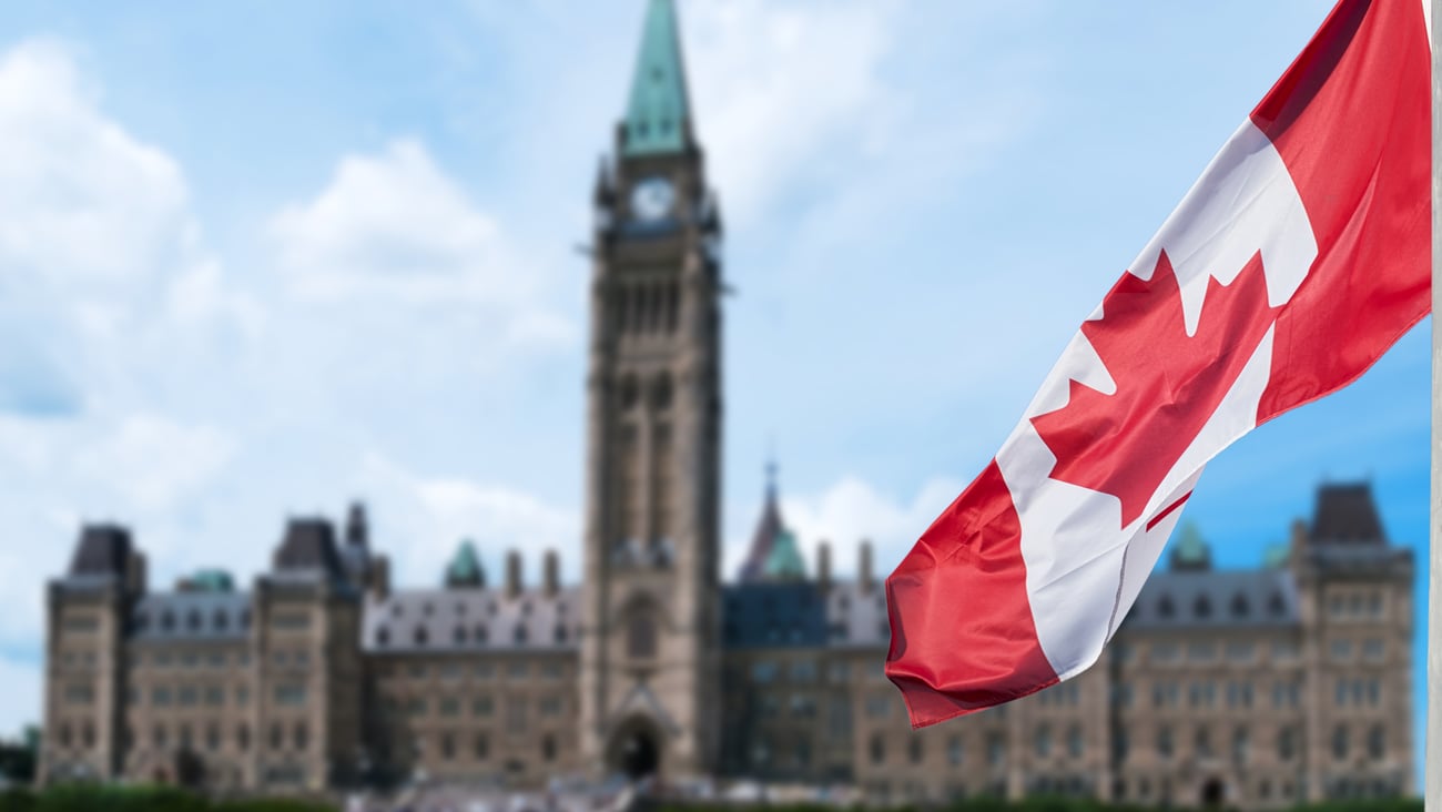 a flag flying in front of Parliament Hill