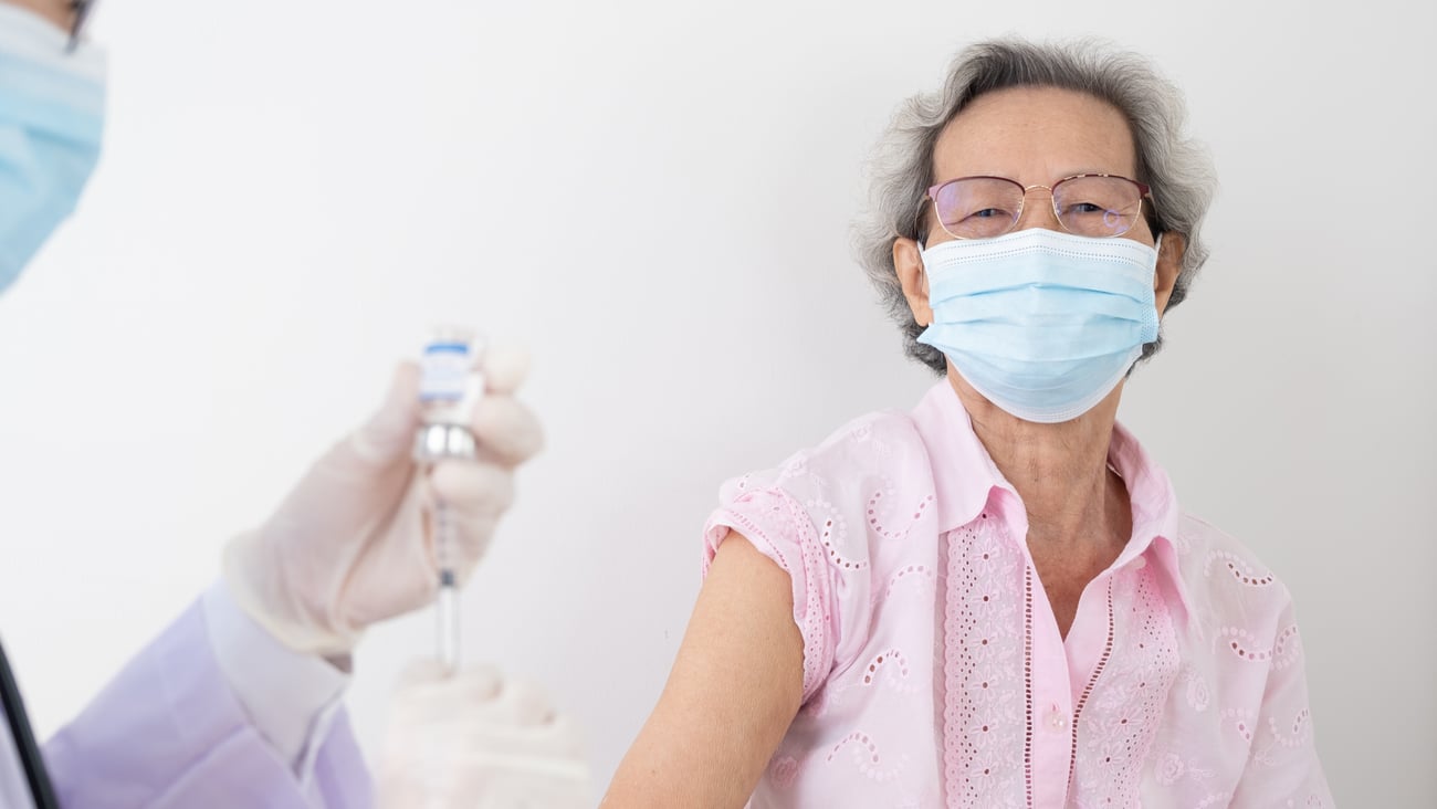 older woman receiving a vaccine