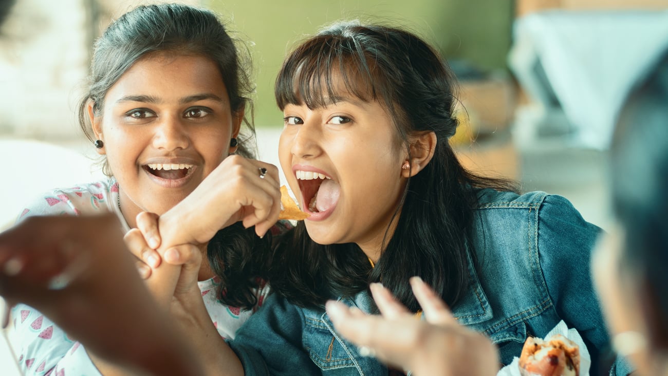 Teenagers sharing food