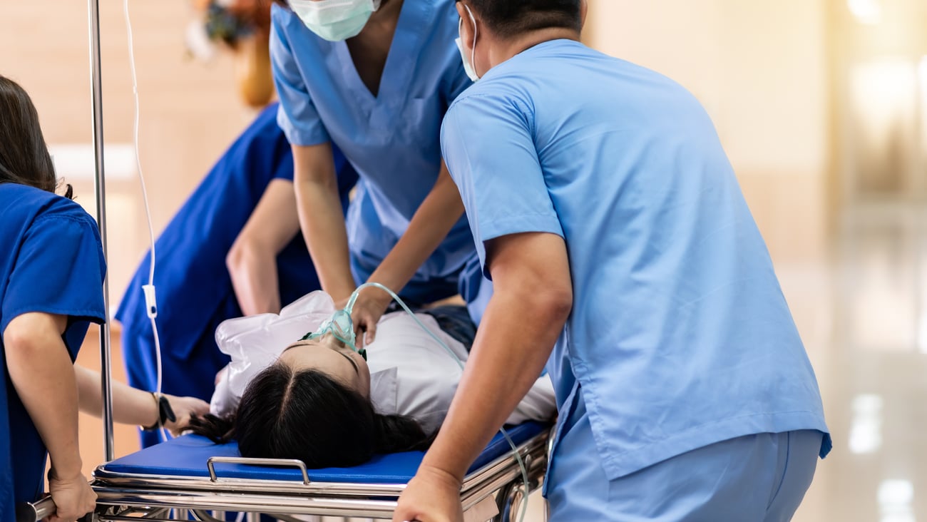 Hospital workers helping patient