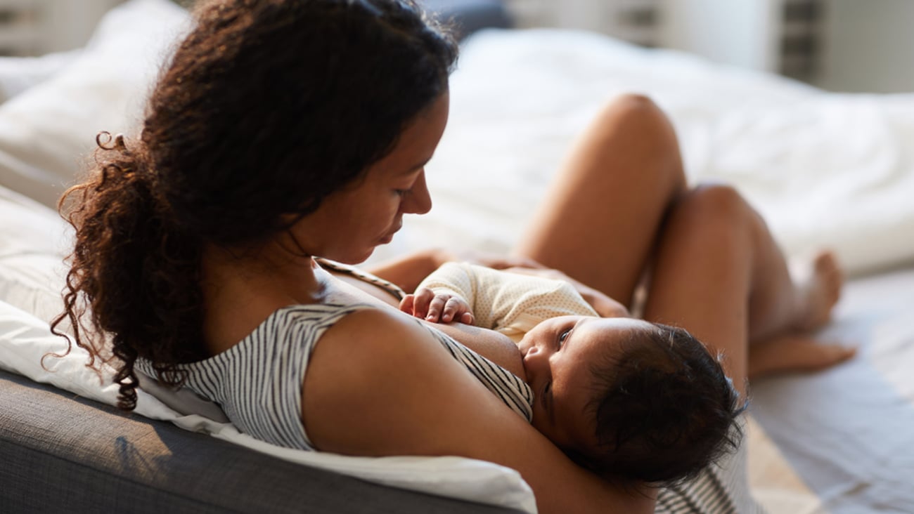 dark haired mombreastfeeding infant