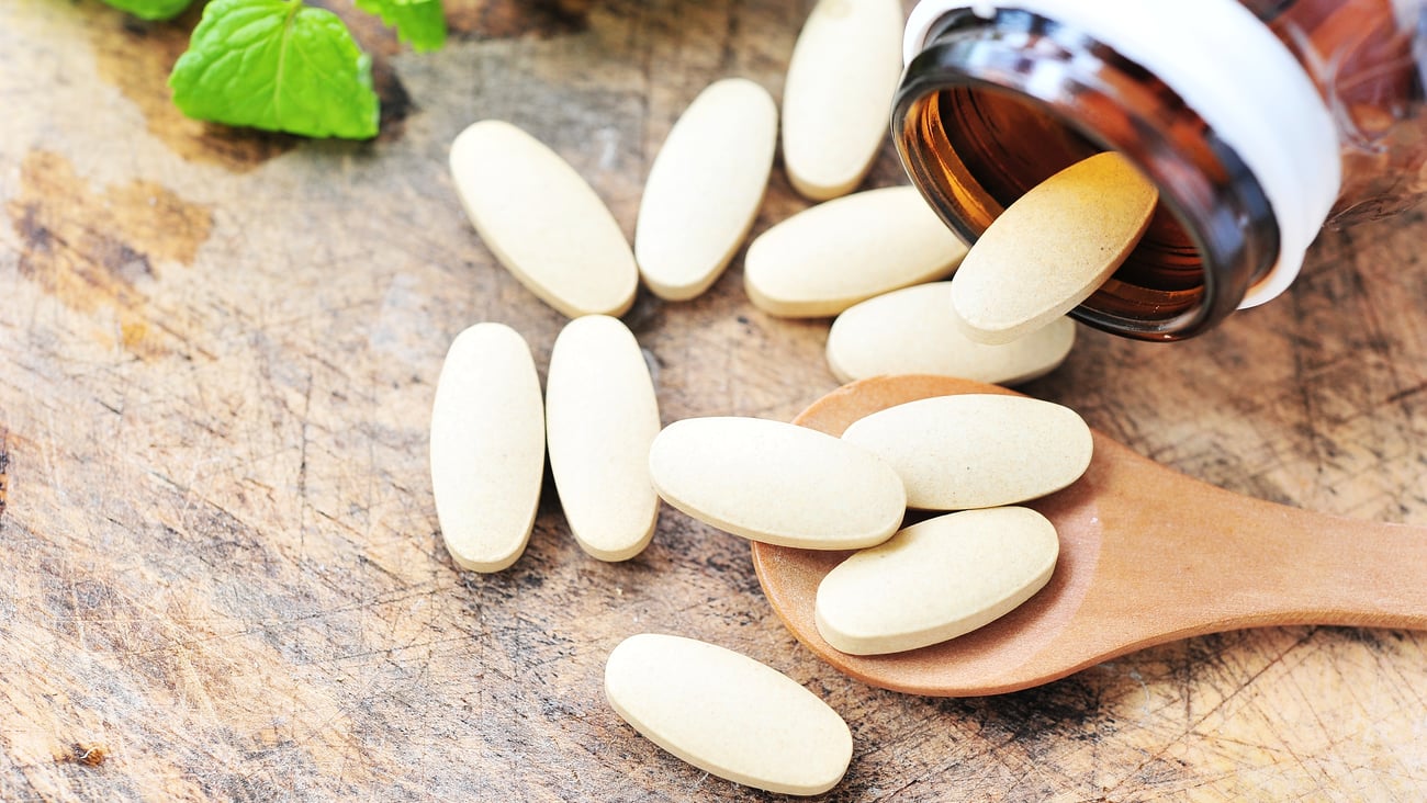 brown bottle with supplements spilling out