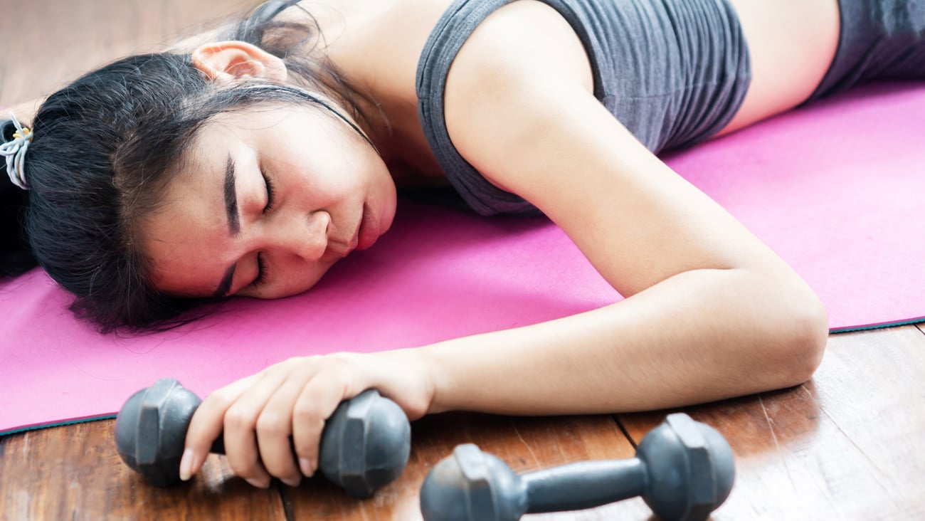 woman-tired-dumbell-mat