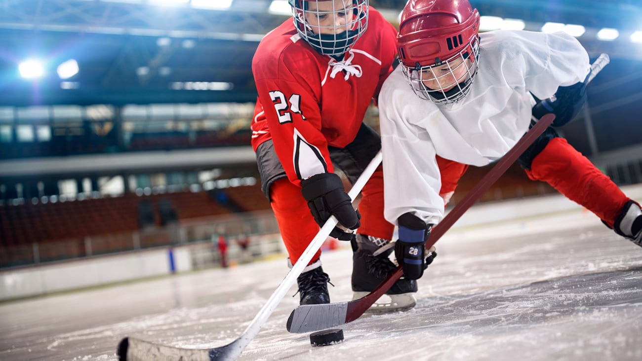 Two kids playing hockey 