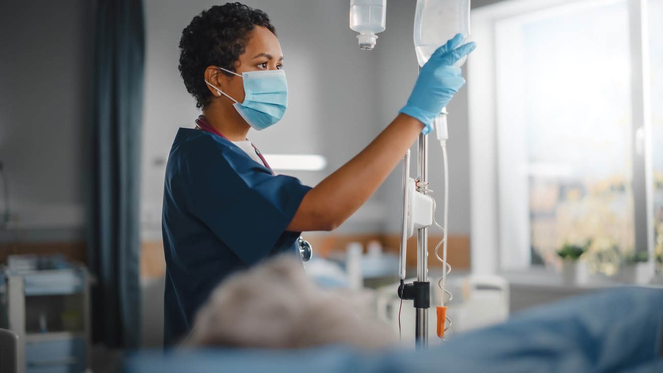 Nurse checking on a patient's IV