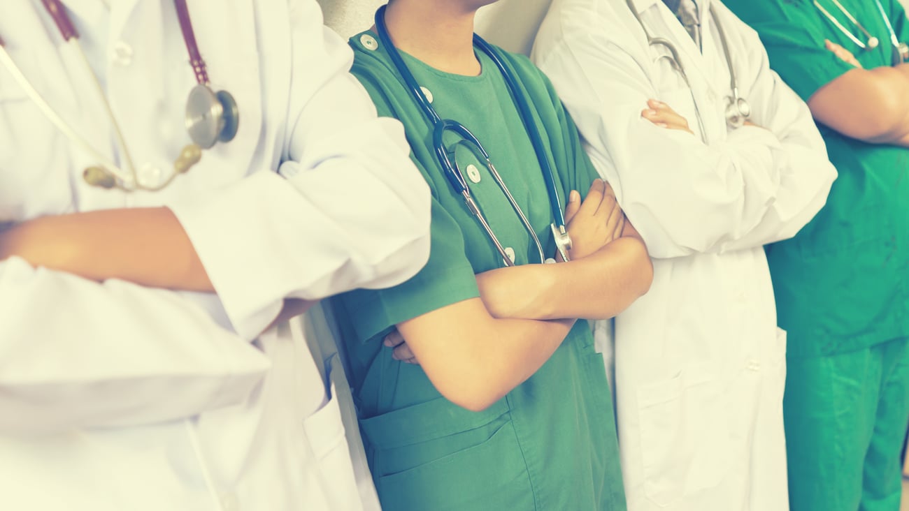 Row of healthcare workers with their arms crossed 