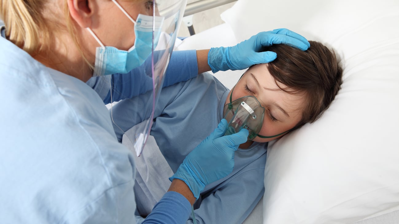 Doctor helping child with a respirator