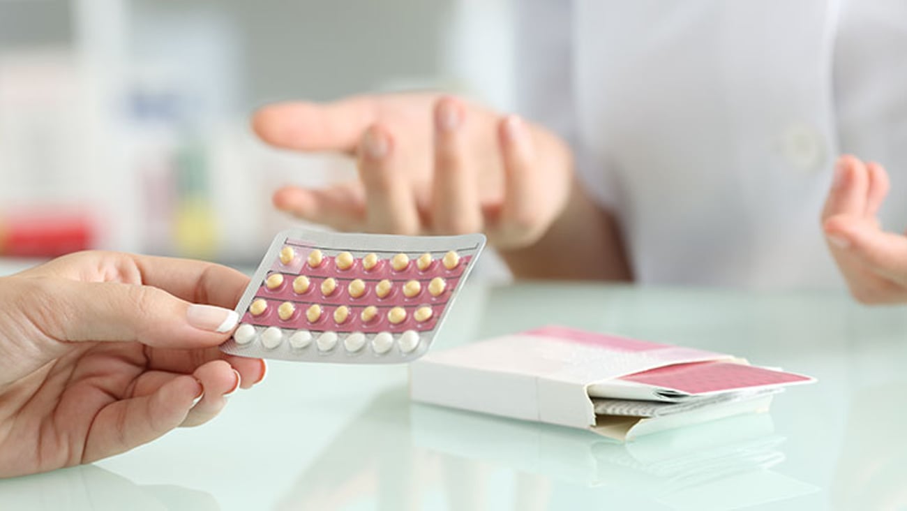 a patient and a pharmacist discuss oral contraceptives