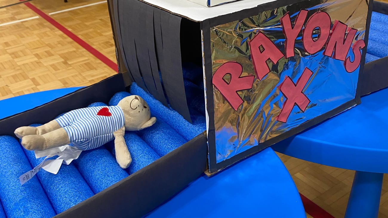 A teddy bear sits on a homemade x-ray machine