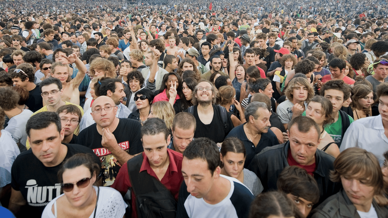 a group of people standing in front of a large crowd of people