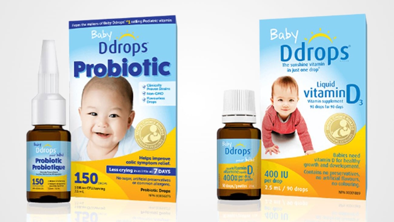 A blue and yellow box of probiotics sits next to a very similar blue and yellow vitamin D drops box