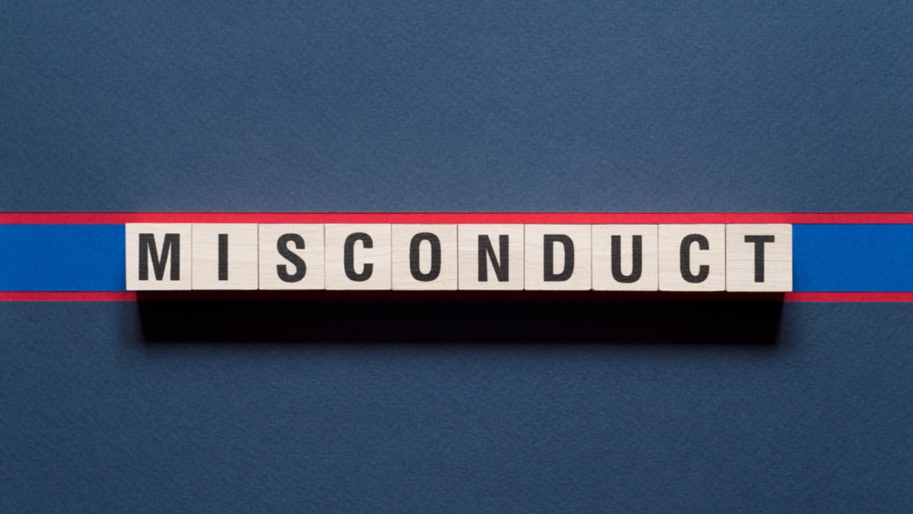 The word misconduct is spelled out in wooden blocks