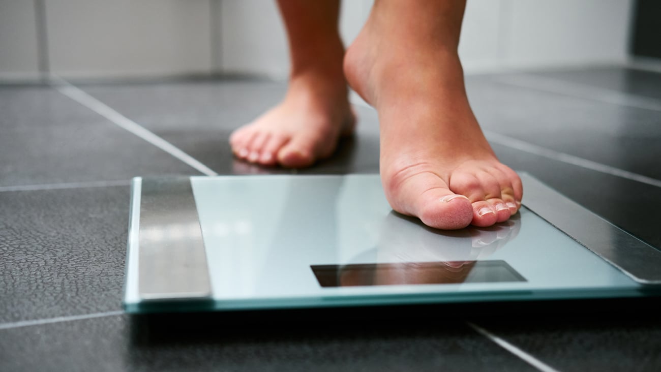 Feet stepping onto a scale