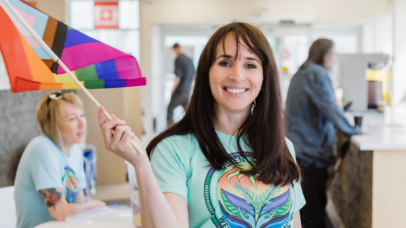 Woman waving the pride progress flag