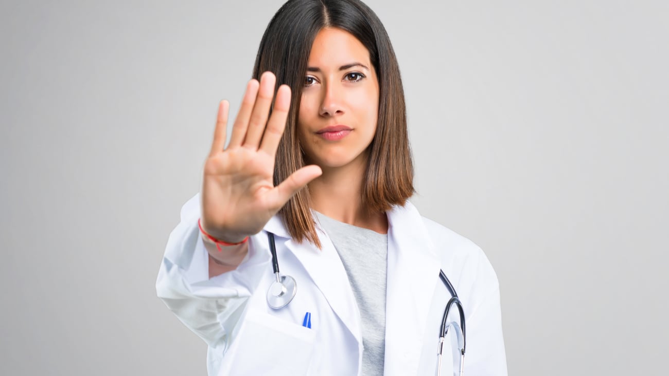 hand outstretched of female healthcare worker indicating stop