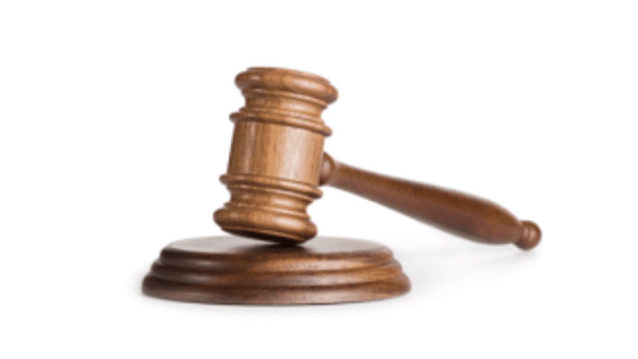 A judges gavel on a white background