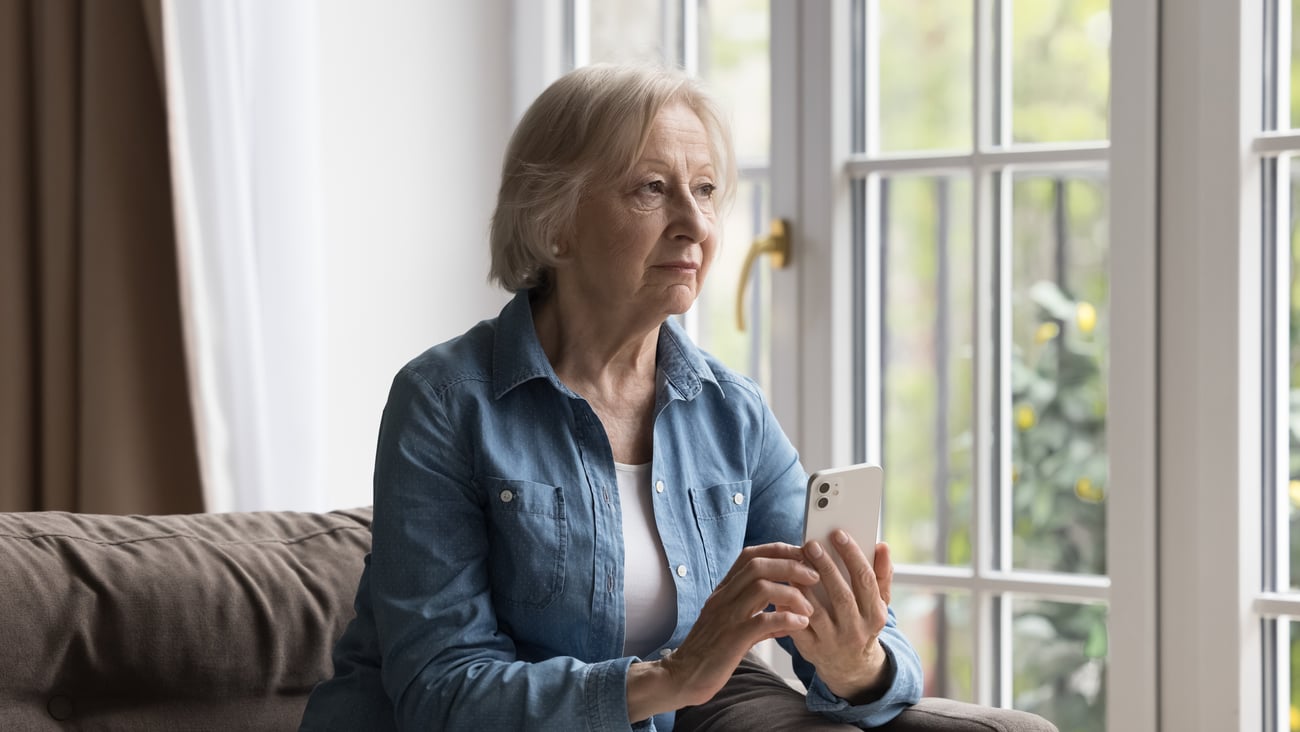 An older white woman using a cellphone to text