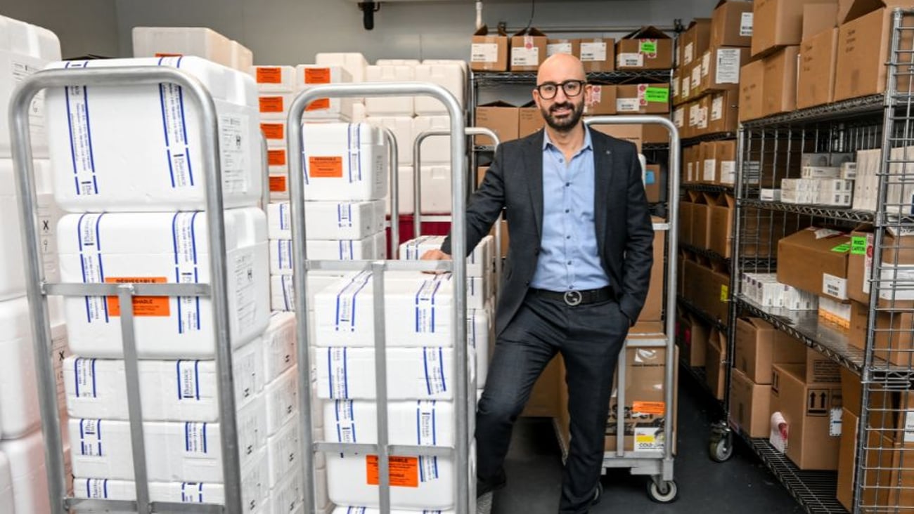 A pharmacist standing in a cold-storage room