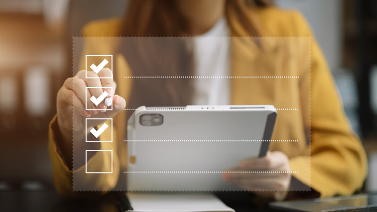 a woman uses a tablet to fill out an online survey