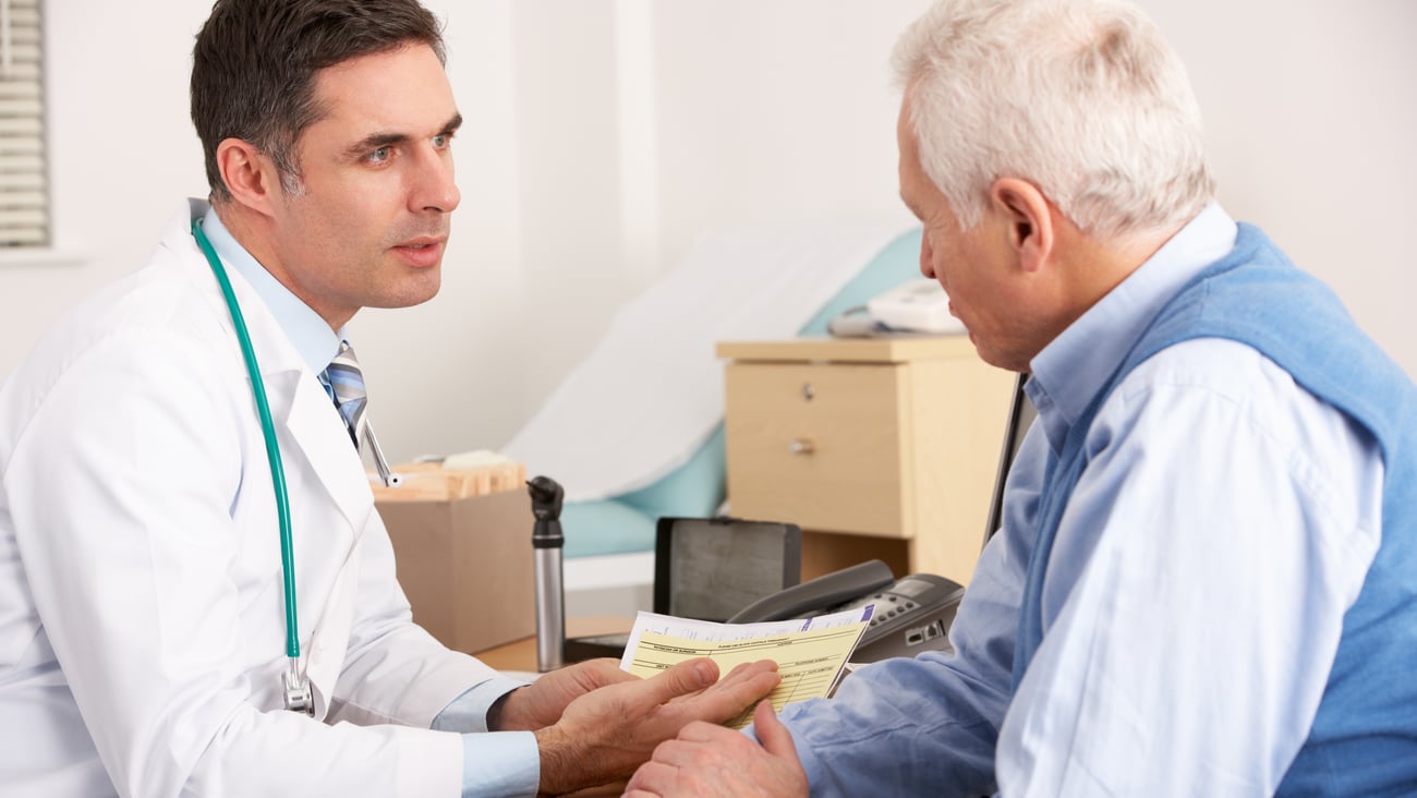 Young white male doctor counselling older white male