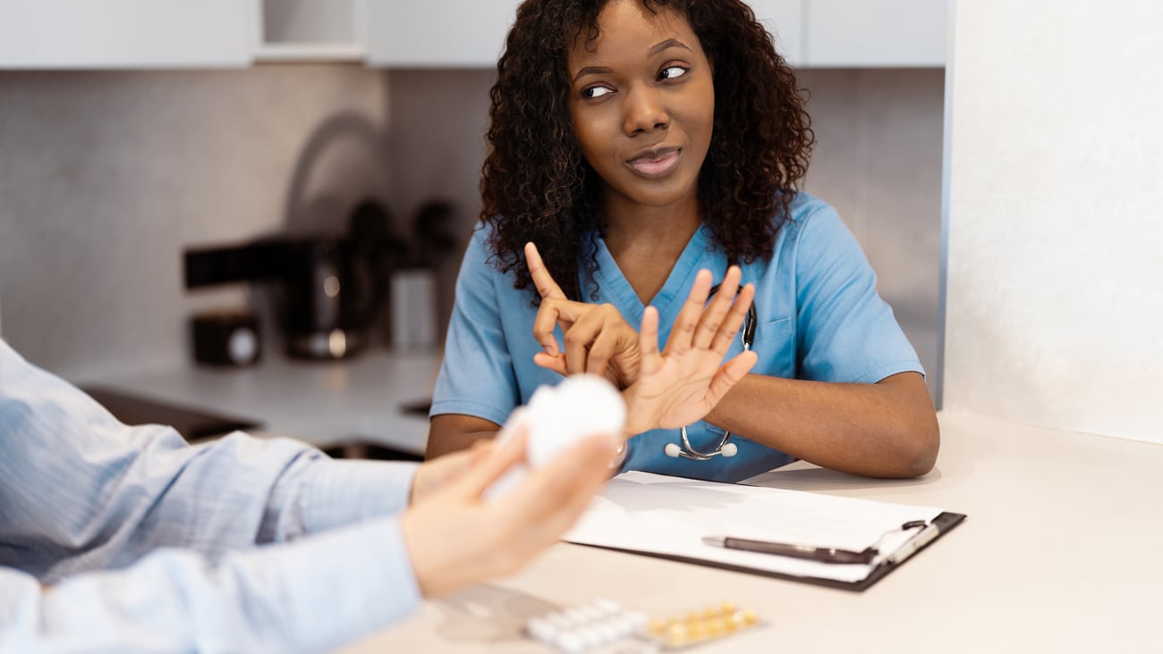 female Black family doc or pharmacist advising patient on medication
