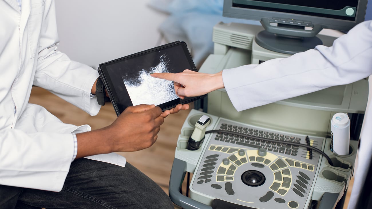 Cropped top view of doctor holding a tablet with ultrasound scan