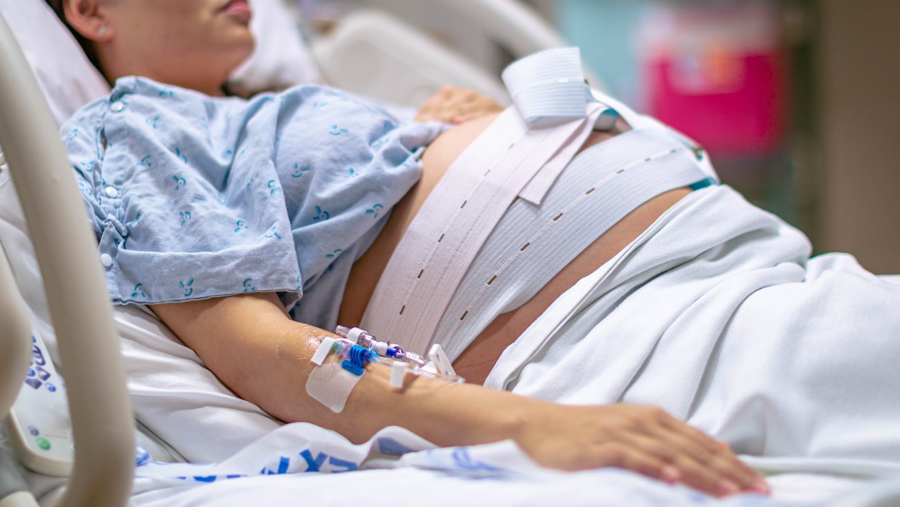 A woman in labour, giving birth in the hospital.