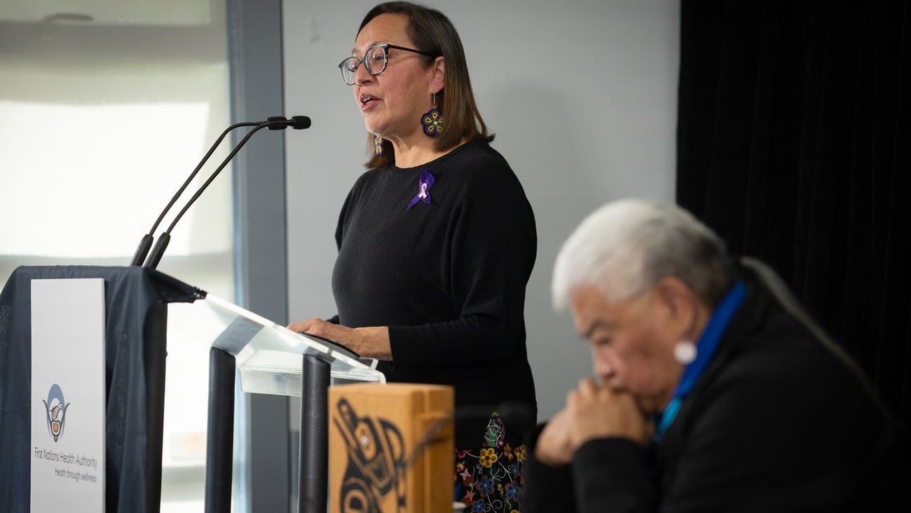 Woman speaking at lectern.