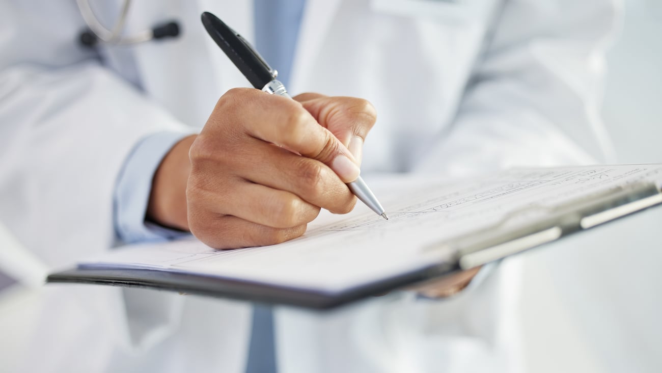 Doctor filling out a form