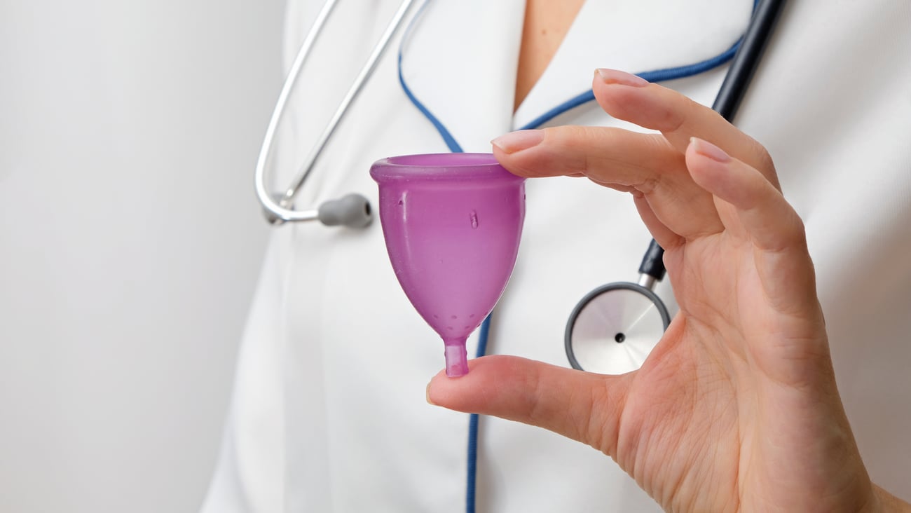 Doctor showing menstrual cup