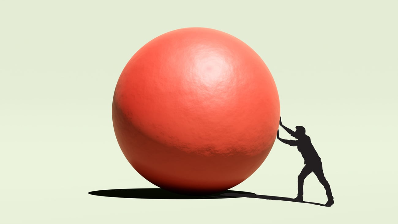 Man pushing red ball 