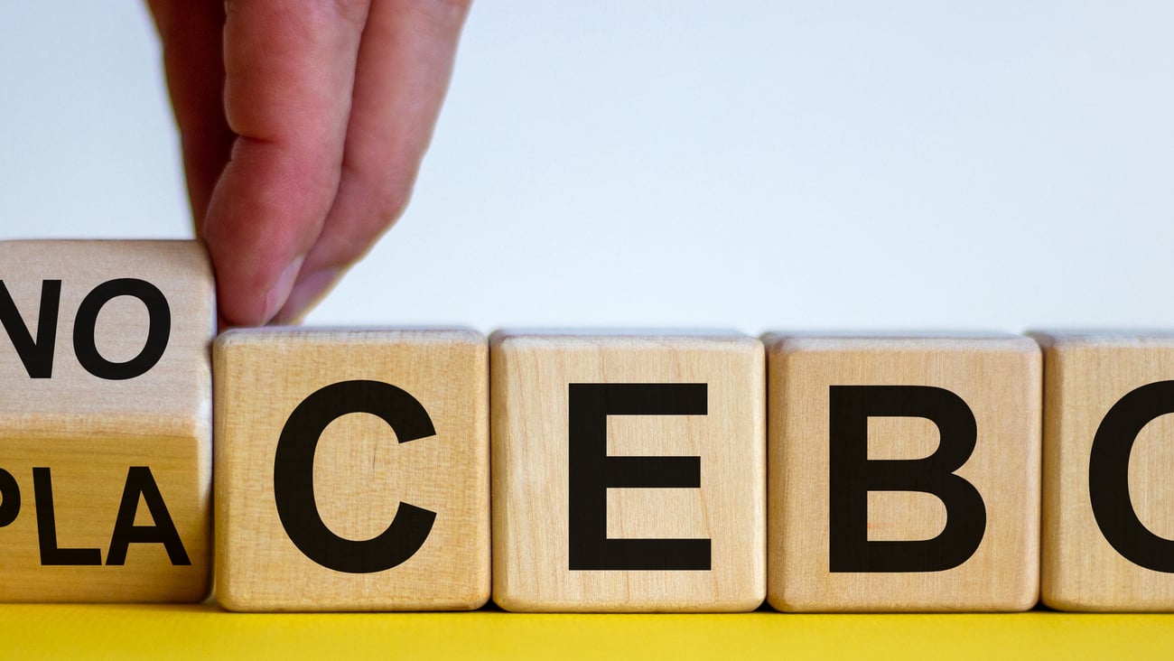 blocks spelling placebo with fingers turning a block to spell "nocebo"