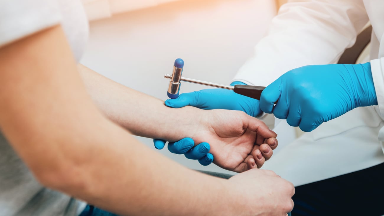 Family doctor examining older patients joints