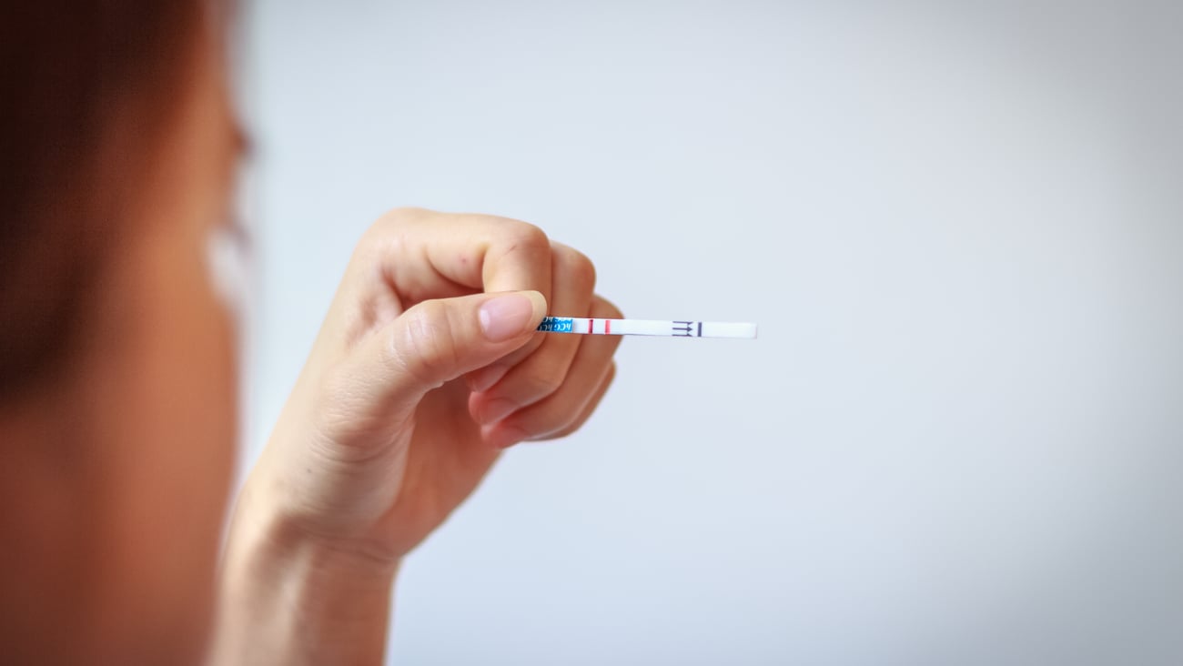 Woman holding up a test strip