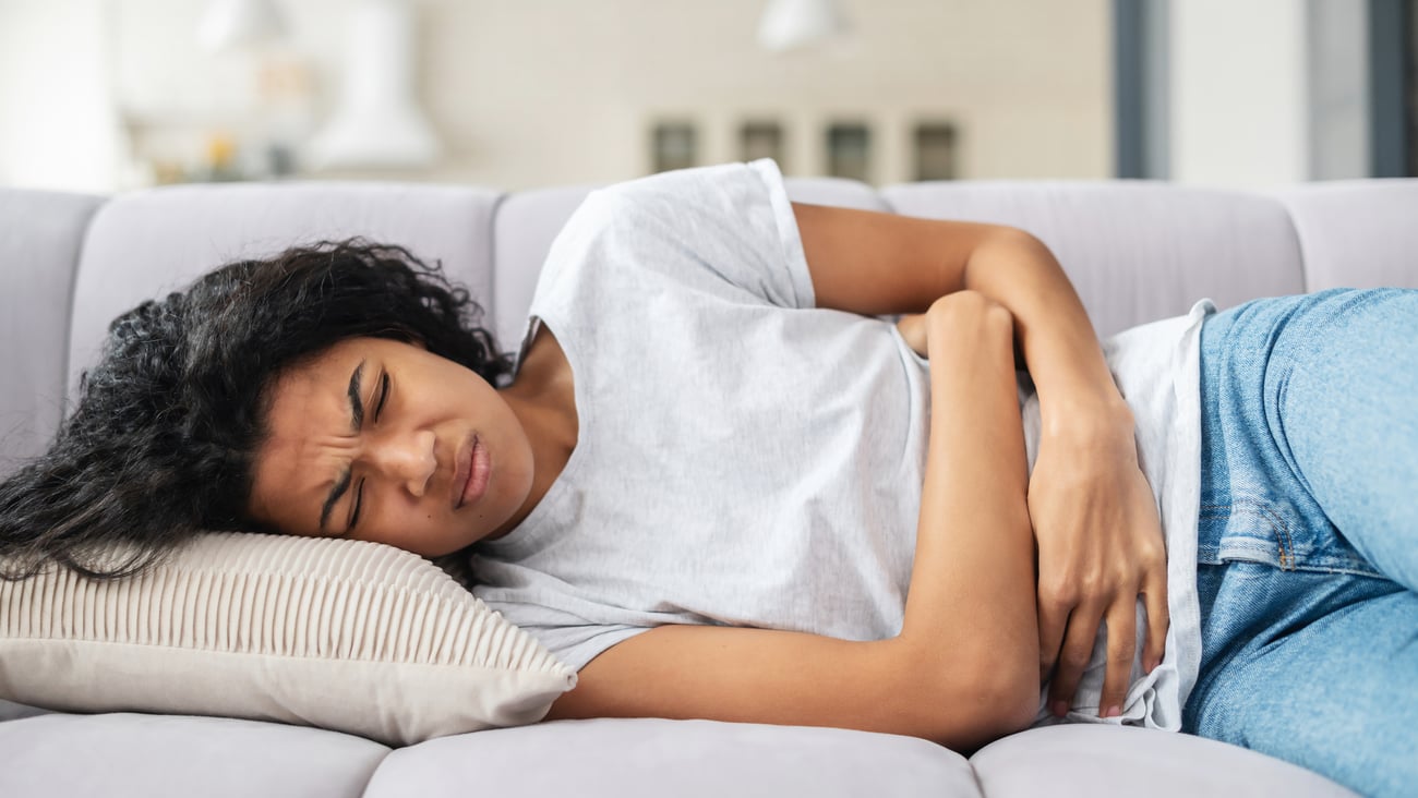 woman with abdominal / menstrual pain lying on her side