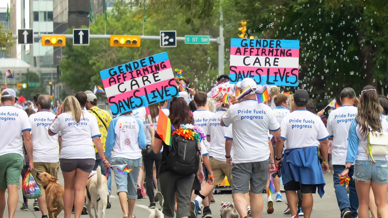 Protesters hold signs in support of gender affirming care in Calgary on Sep 3, 2023. (Shutterstock)