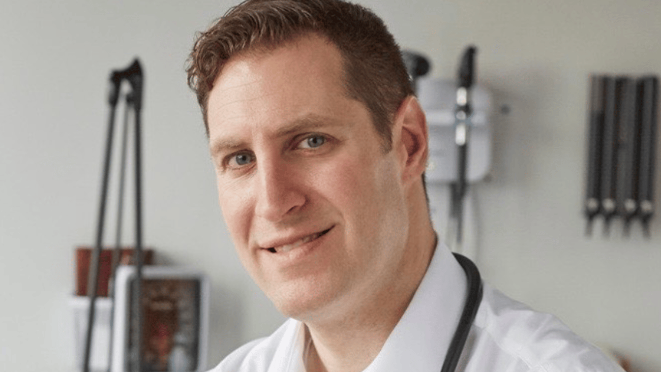 Dr. Eric Cadesky smiling for a photo in an exam room