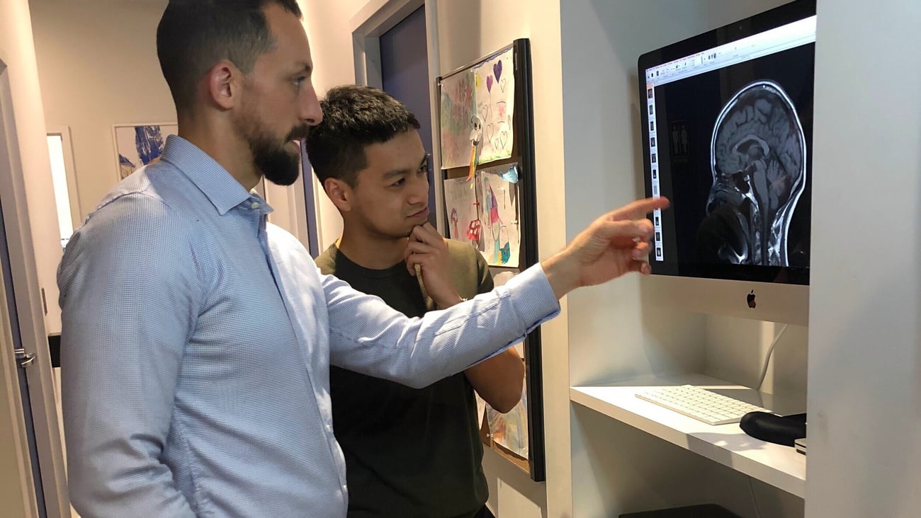 Dr. Evan Lewis chatting with a student about a brain scan