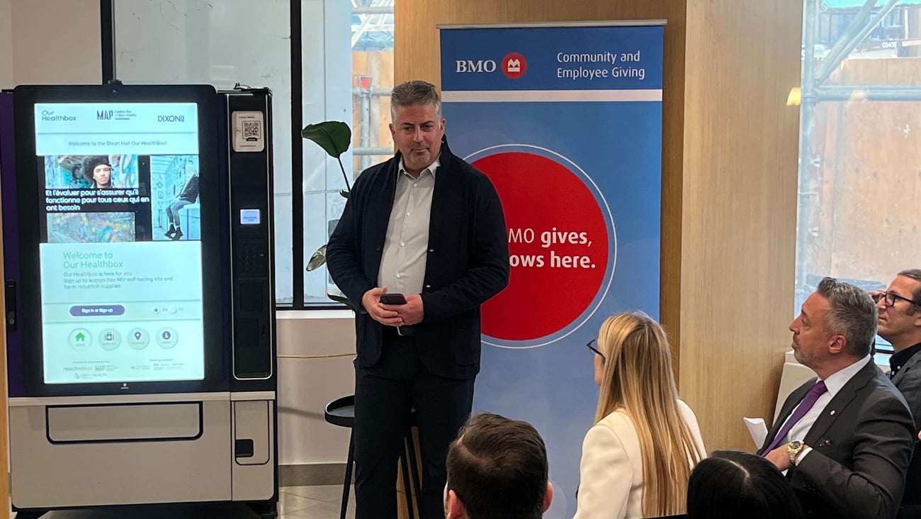 Dr. Sean B. Rourke presents an Our Healthbox machine. (REACH Nexus)