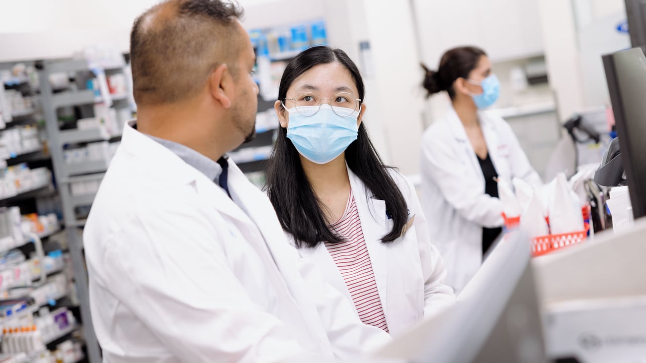 PharmD student talking to a pharmacist on her practicum. 