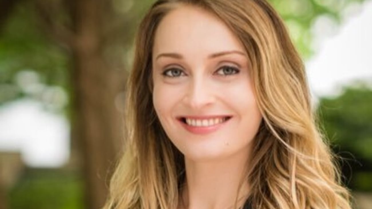 Justyna Bartoszko, a young woman, smiling for a photo