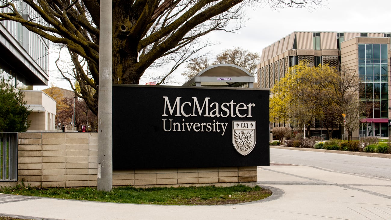 The emblem and name sign at entrance to McMaster University in Hamilton, Ontario