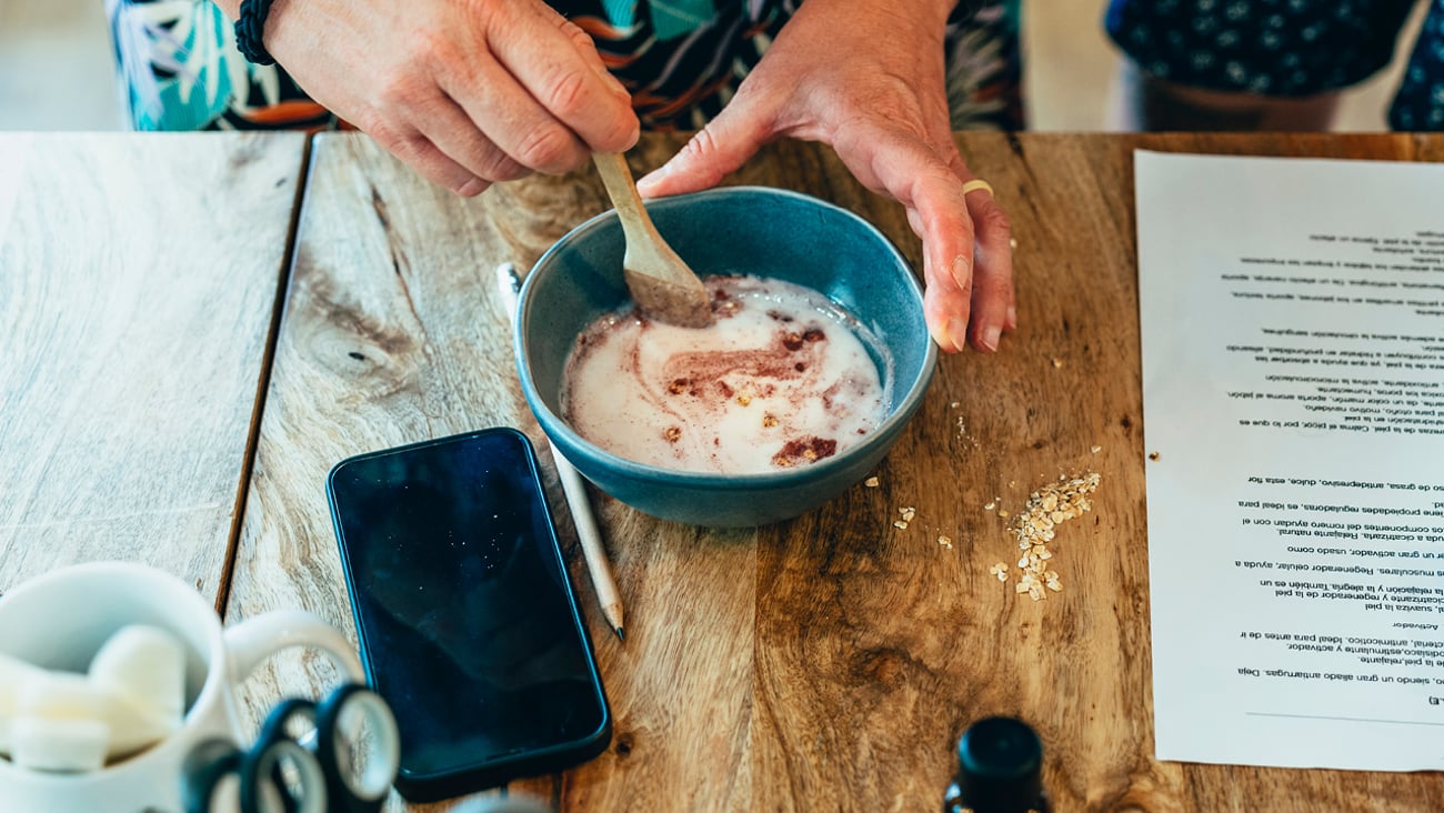 Close up of a woman's hands as she mixes a homemade lotion